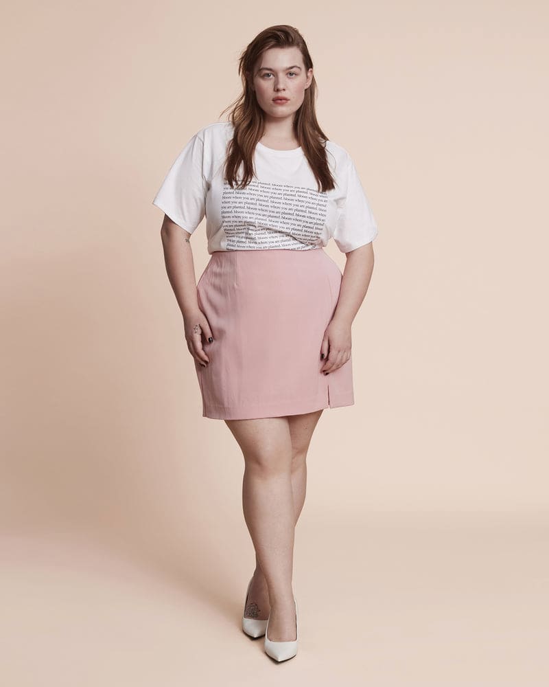 Front of a model wearing a plus size Darci Mini Skirt in Pretty Pink by 11 Honoré Collection. | dia_product_style_image_id:231151